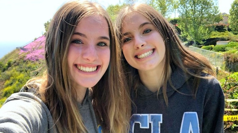 Noelle Sheldon and Cali Sheldon smiling together in UCLA sweatshirts