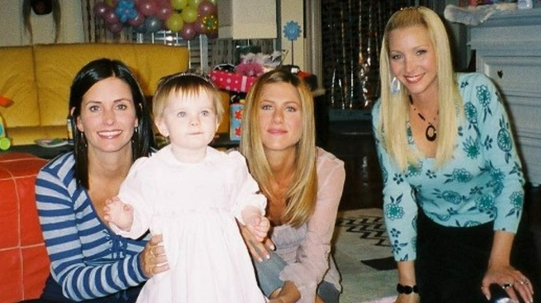 Courtney Cox holding baby Noelle Sheldon next to Jennifer Anniston and Lisa Kudrow