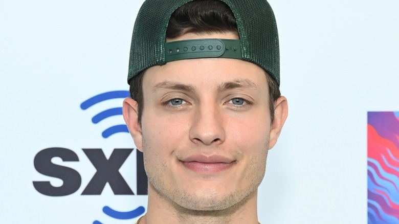 Matt Rife green baseball cap