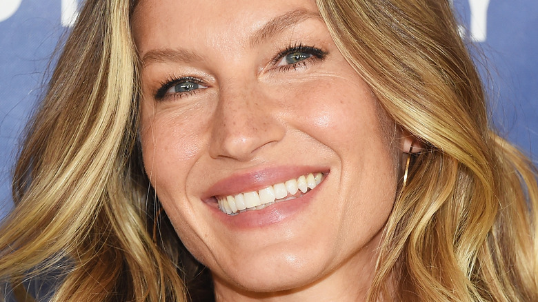 Gisele Bundchen smiles with wavy hair down