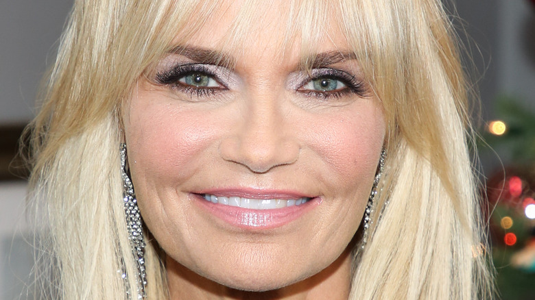 Kristin Chenoweth smiles in a black sequined outfit