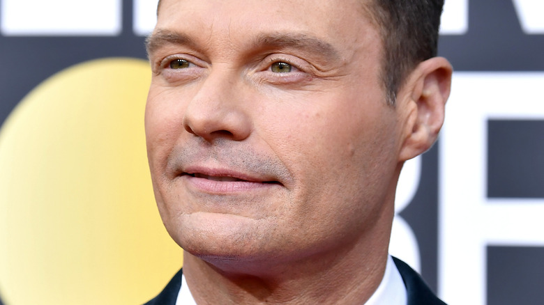 Ryan Seacrest smirking 