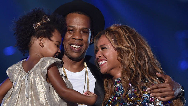 Jay-Z and Beyoncé pose with Blue Ivy onstage