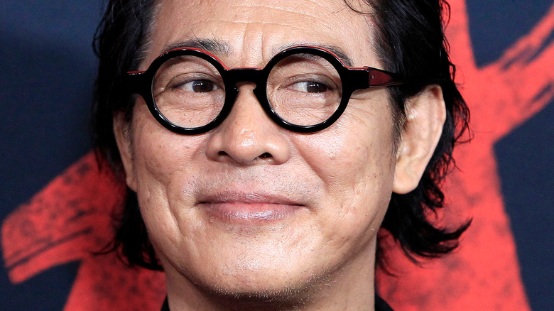 Jet Li smirking round glasses