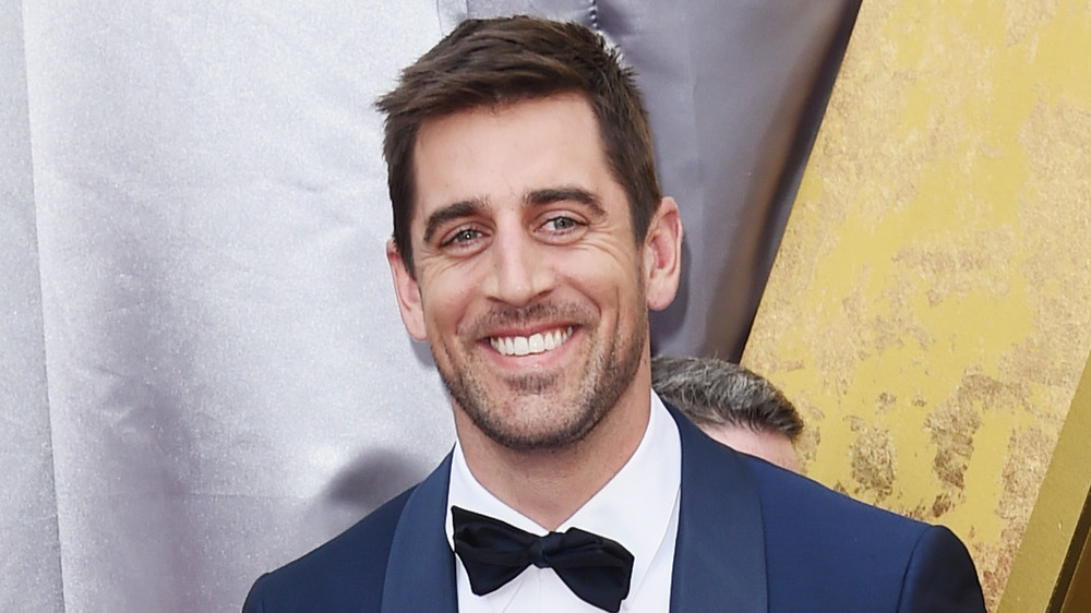 Aaron Rodgers smiling at the 88th Annual Academy Awards