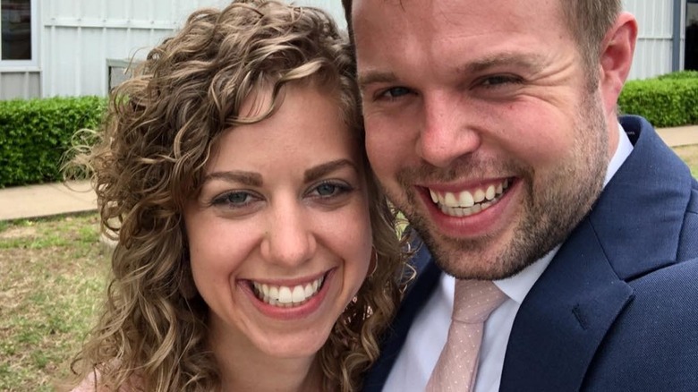 Abbie and John David Duggar outside a church