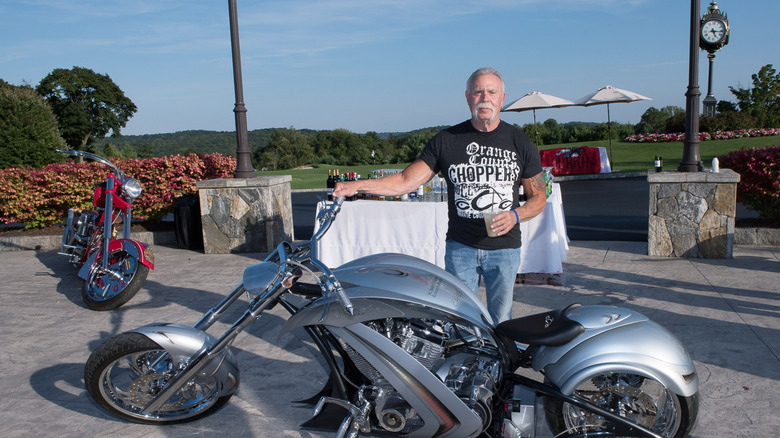 Paul Teutul Sr. posing with bike