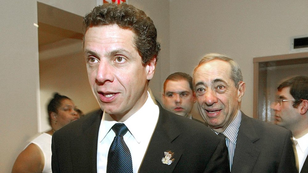 Andrew Cuomo walking in front of Mario Cuomo
