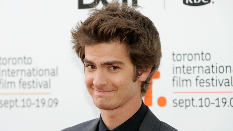 Andrew Garfield in a gray jacket