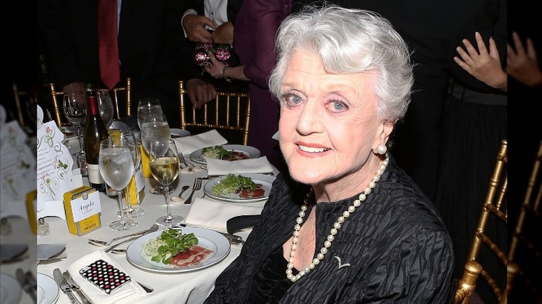 Angela Lansbury sitting at table