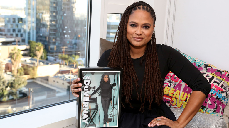Ava DuVernay holding her Barbie
