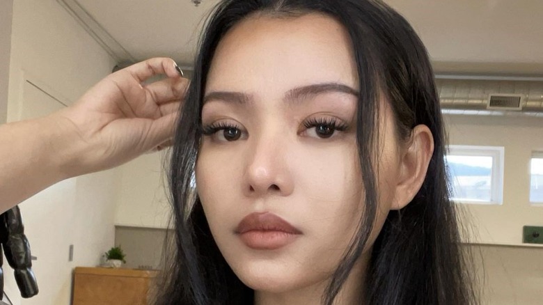 Bella Poarch touching hair