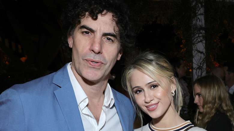 Sacha Baron Cohen and Maria Bakalova posing together