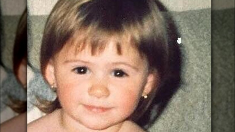 Maria Bakalova as smiling as a young child 