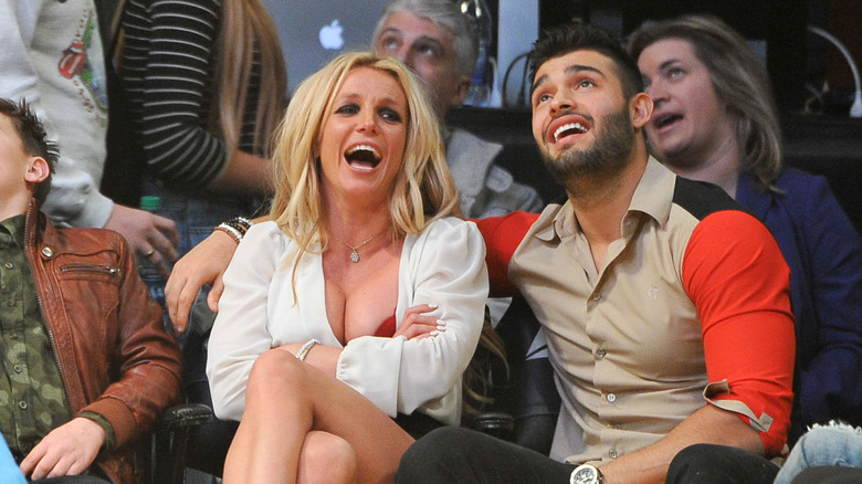 Britney Spears and Sam Asghari laughing at a basketball game