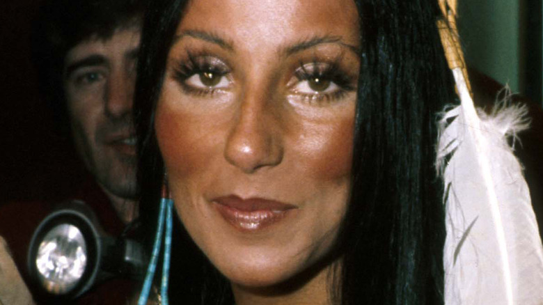 Cher with feather in hair
