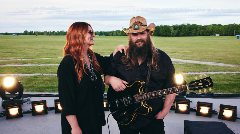 Chris Stapleton poses with his wife in front of Bonaroo Farm