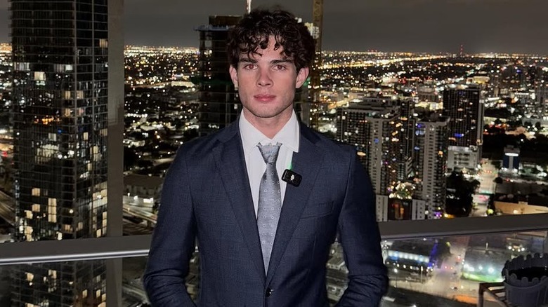 Clavicular posing in front of a city skyline