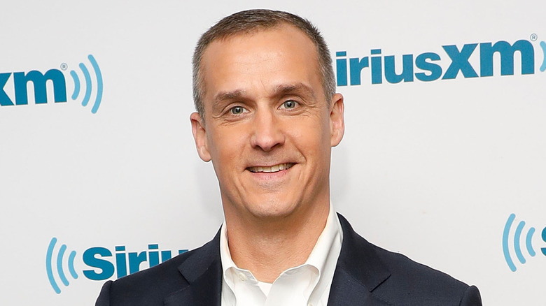 Corey Lewandowski poses on a red carpet.
