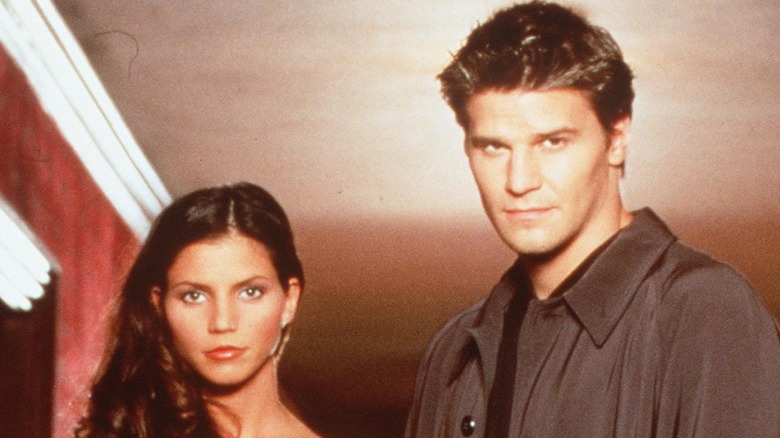 David Boreanaz and Charisma Carpenter posing for cameras 