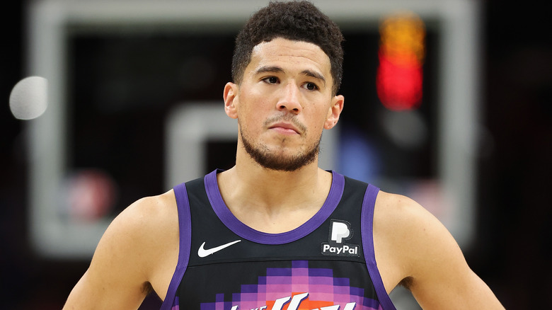 Devin Booker, posing on the court