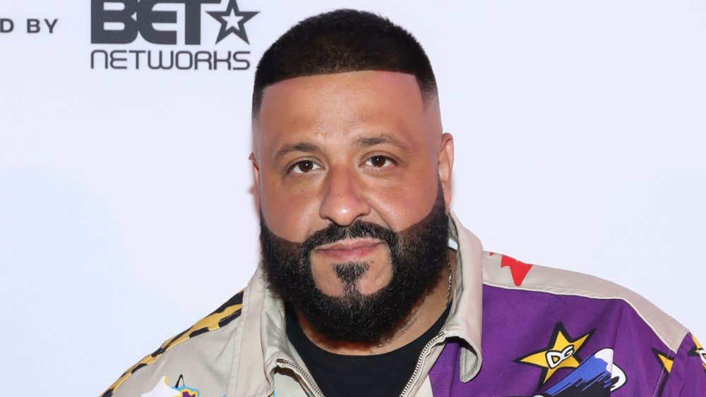 DJ Khaled in a purple and beige bomber