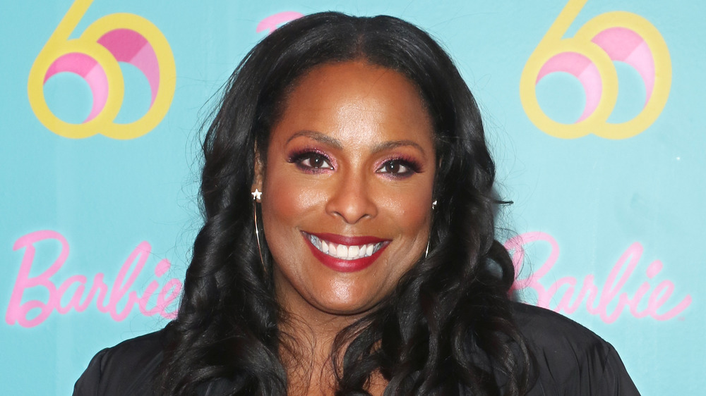 DJ Spinderella smiling on the red carpet