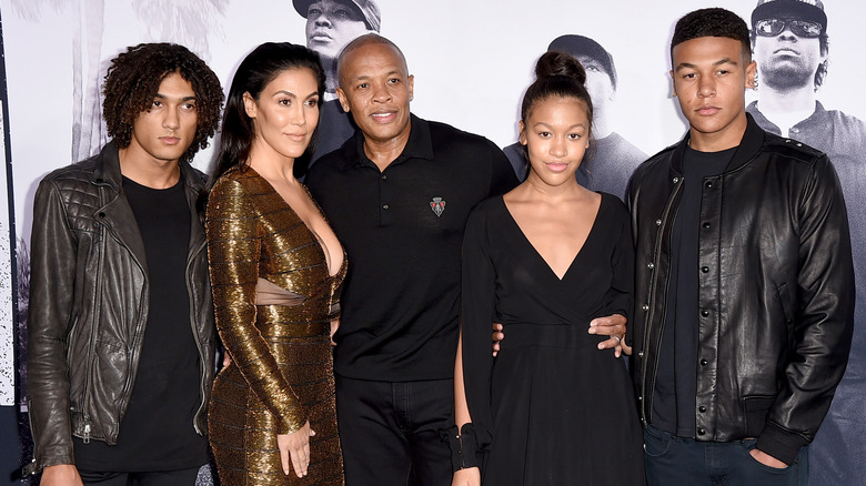 Dr. Dre and Nicole Young smiling and posing with Truly Young, Truice Young, and Tyler Young
