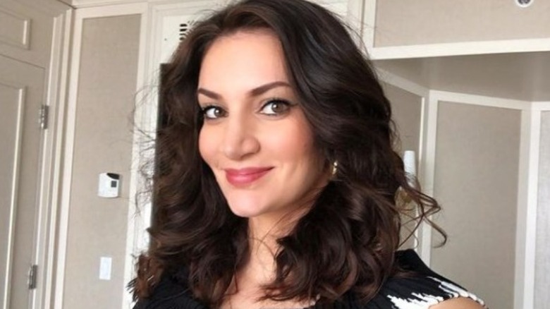 Sophie Brussaux taking a selfie in black sweater