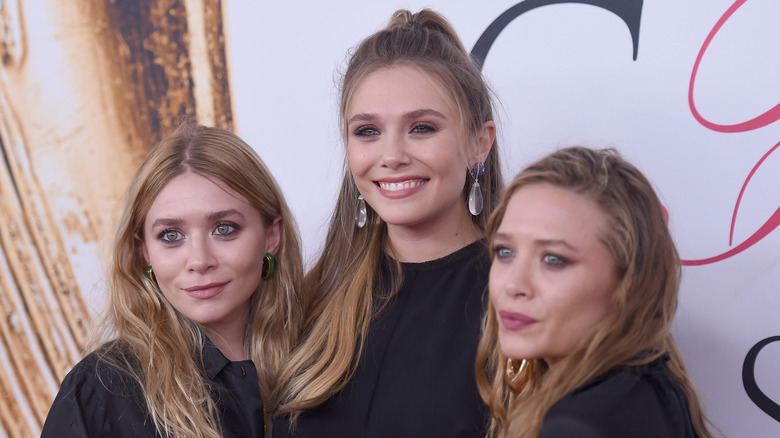 Ashley Olsen, Elizabeth Olsen, and Mary-Kate Olsen posing together