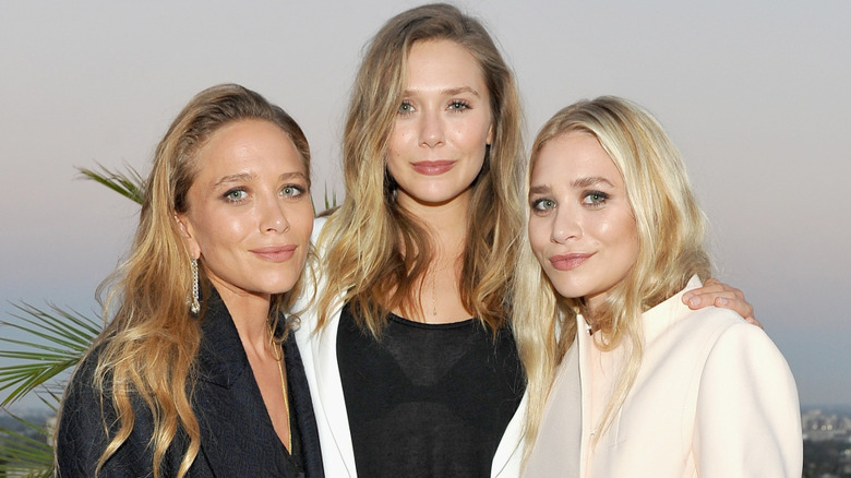Mary-Kate Olsen, Elizabeth Olsen, and Ashley Olsen posing together