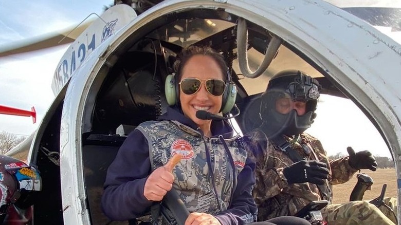 Emily Compagno posing for cameras in fighter plane