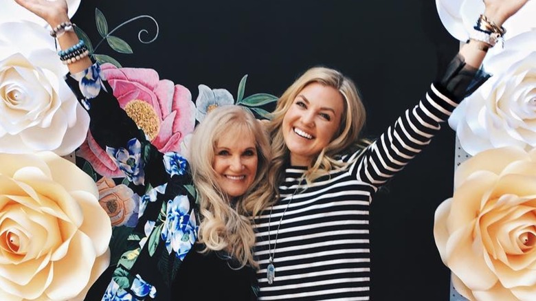 Lori Frantzve Erika Kirk smiling hands in the air