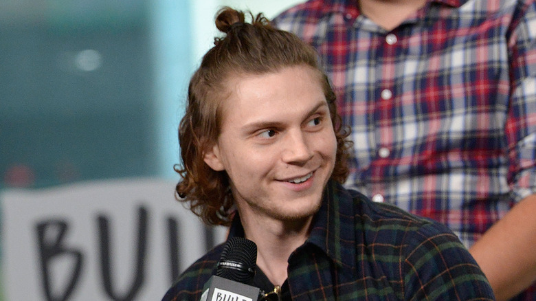 Evan Peters with hair in bun