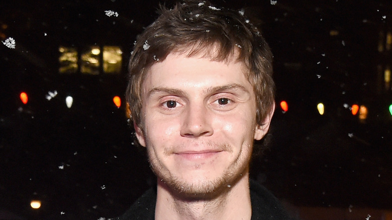 Evan Peters smiling in the snow