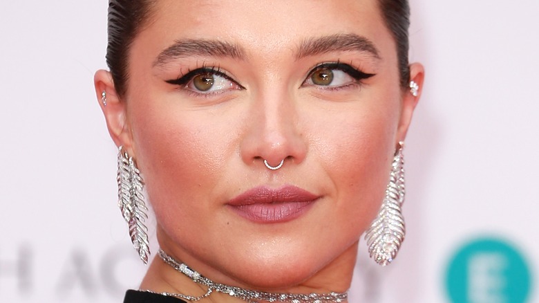 Florence Pugh looking over her shoulder