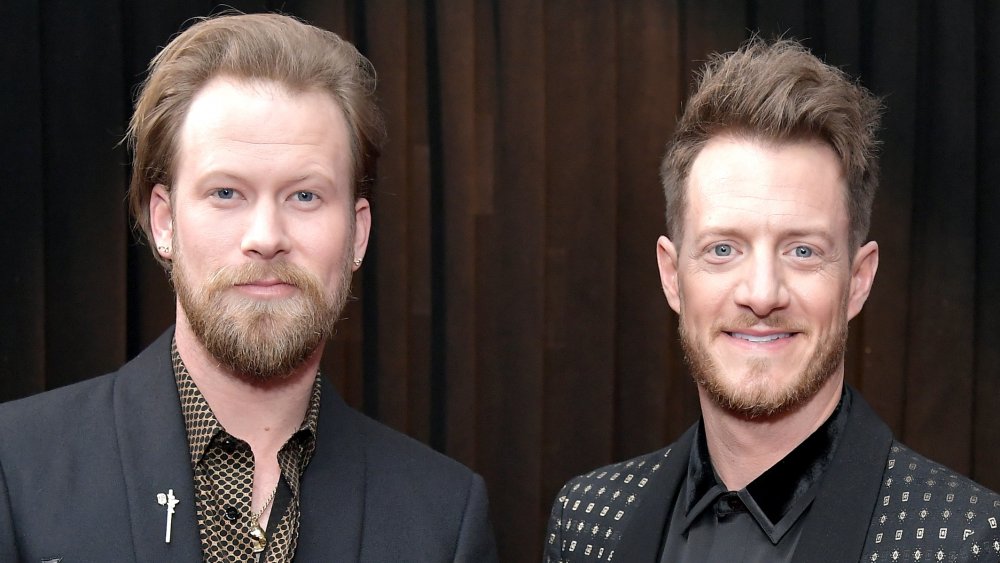 Brian Kelley and Tyler Hubbard both in black suits, smiling