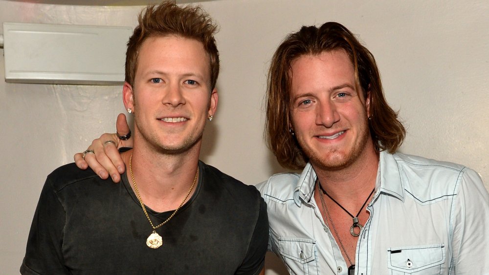 Tyler Hubbard and Brian Kelley arm in arm