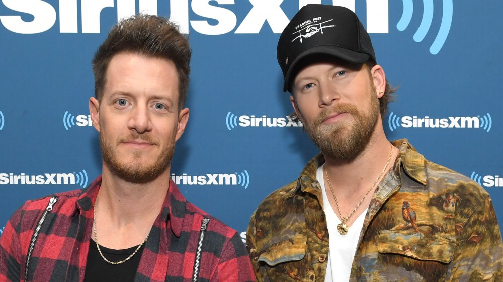 Tyler Hubbard and Brian Kelley in front of SiriusXM wall