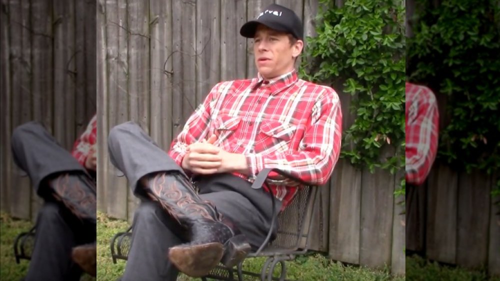 Brother Jervel sitting, cowboy boots on