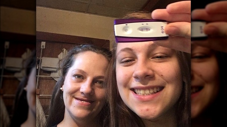 Carli Meisberger holding a pregnancy test 