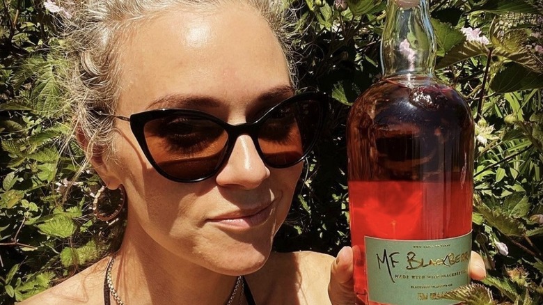 Hilarie Burton holding gin bottle