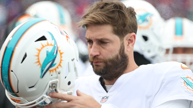 Jay Cutler holding Dolphins helmet 