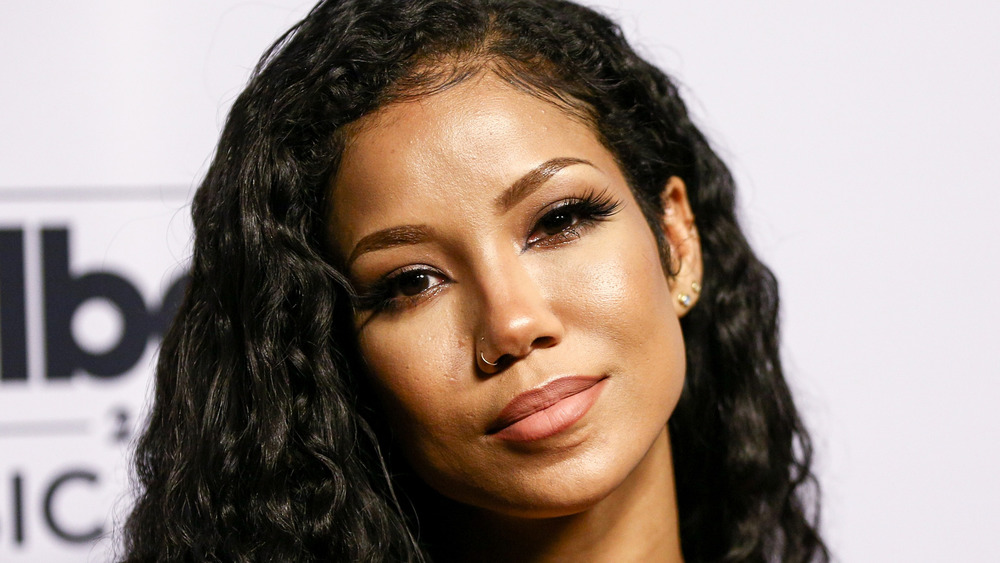 Jhene Aiko posing at step and repeat