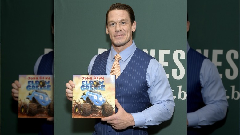John Cena holding his book
