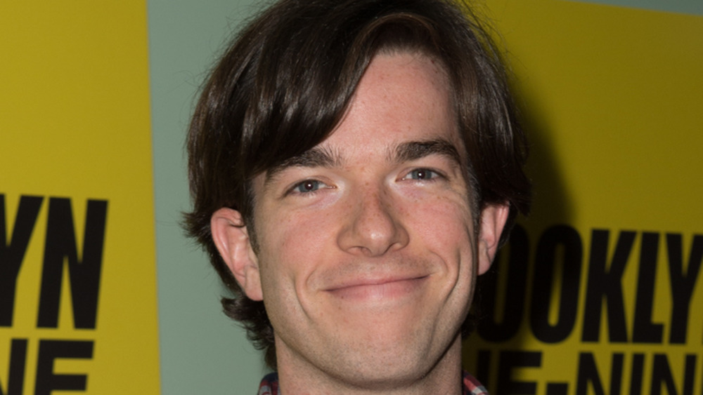 John Mulaney grinning