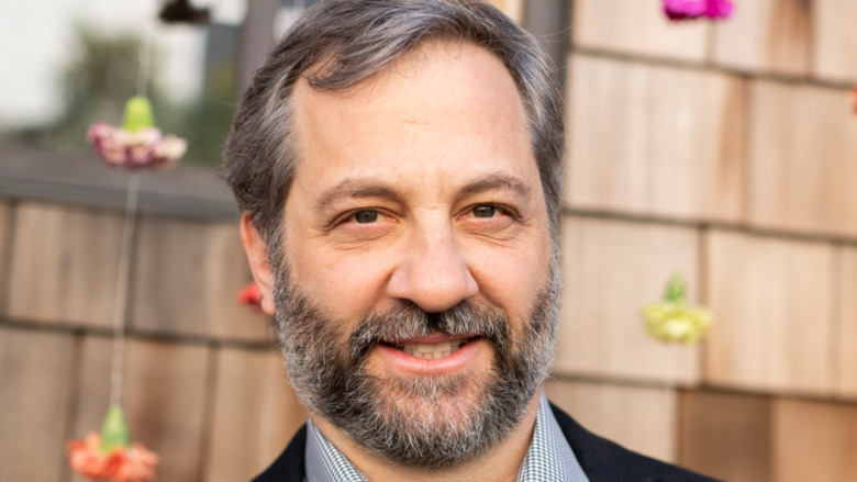 Judd Apatow in front of flowers