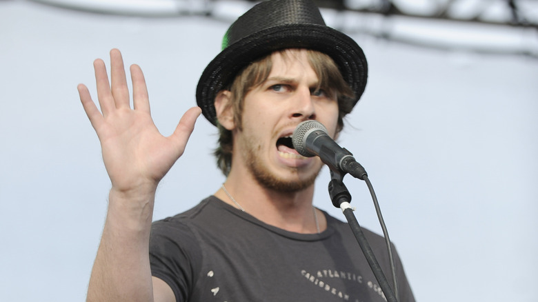 Mark Foster with hand up on stage