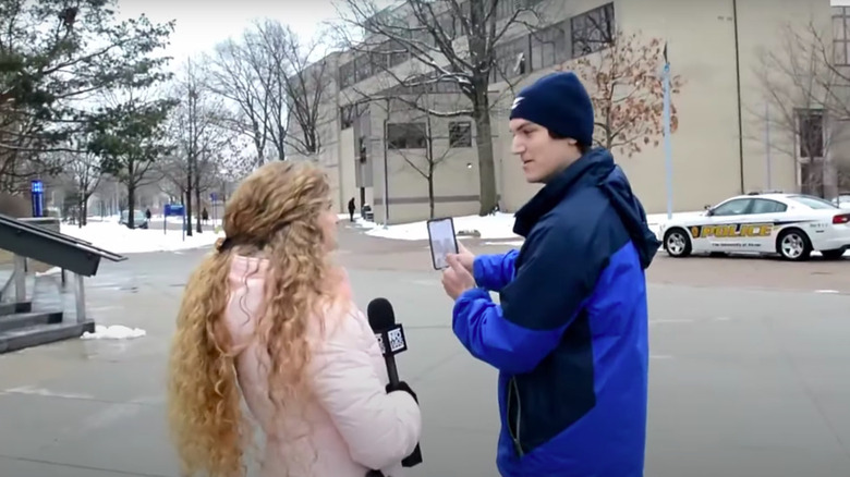 Kaitlin Bennett in pink coat, interviewing man