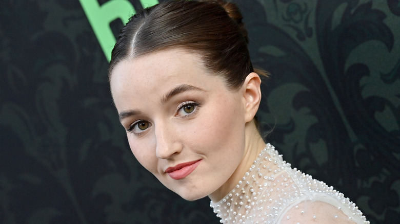 Kaitlyn Dever smiling while wearing a pearl embellished dress